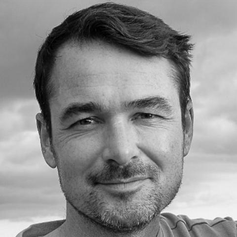 Neil Ingham has short dark hair and a beard.