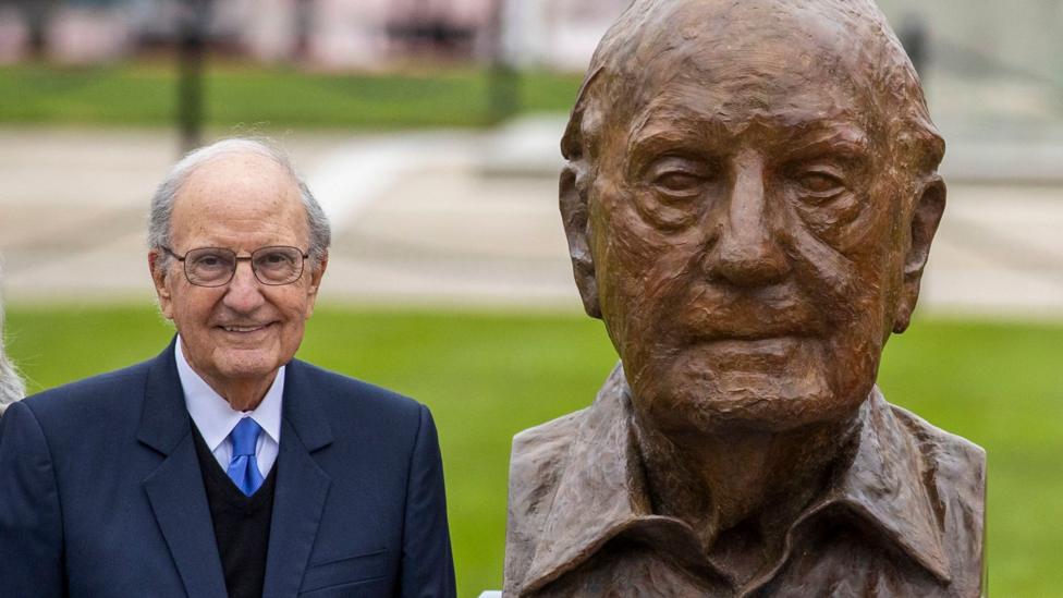 Senator George Mitchell stands beside a newly unveiled bust of himself by Irish visual artist Colin Davidson, during the three-day international conference at Queen's University Belfast to mark the 25th anniversary of the Belfast/Good Friday Agreement.