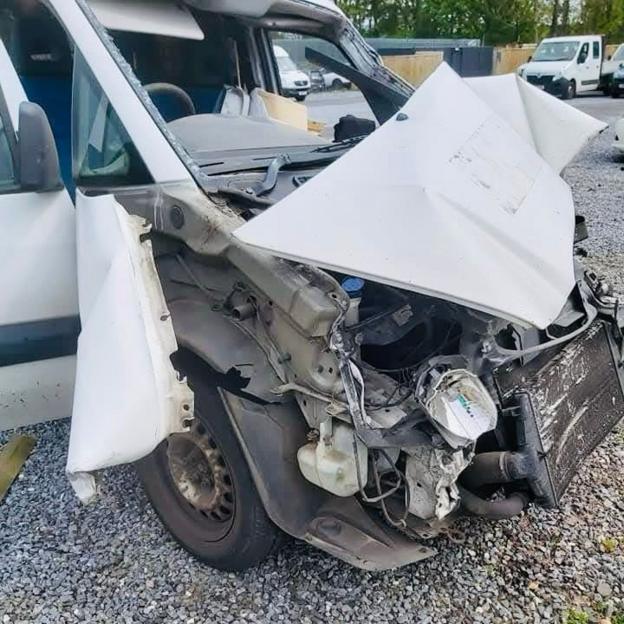 Close up of the mangled front of a white van