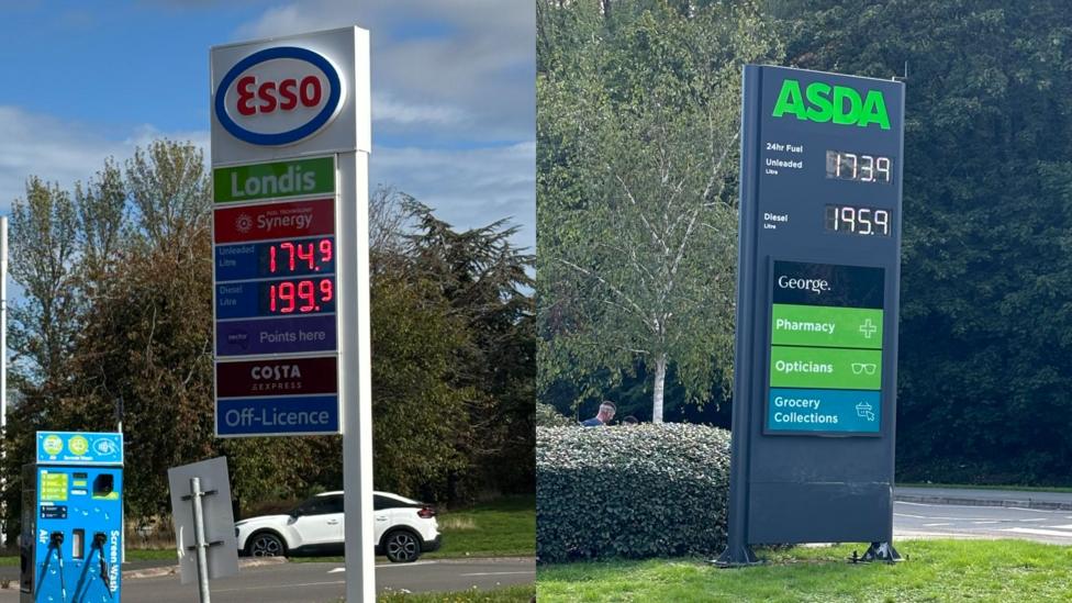 There are two petrol towers with numbers on. On the left, it says 'Esso' then 'Londis and Synergy' underneath. The prices are in red numbers - with the unleaded price being 174.9 and the diesel being 199.9. To the right, there is a petrol board from 'Asda'. It is a dark material and shows unleaded as 173.9 and diesel as 195.9.