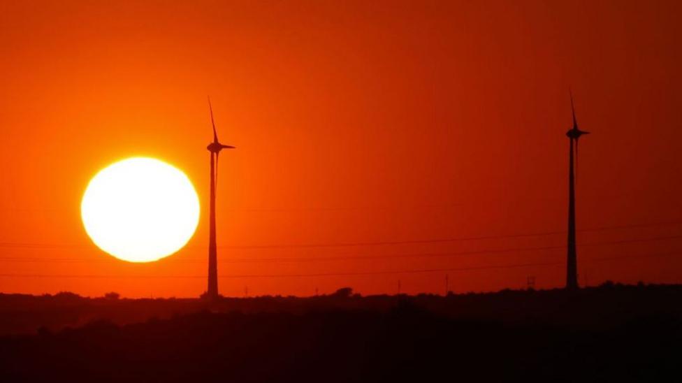 Windmills are seen at sunset near Jaisalmer in Rajasthan state