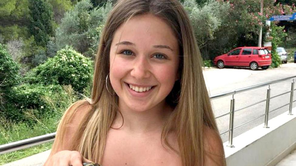A girl is pictured smiling at the camera.