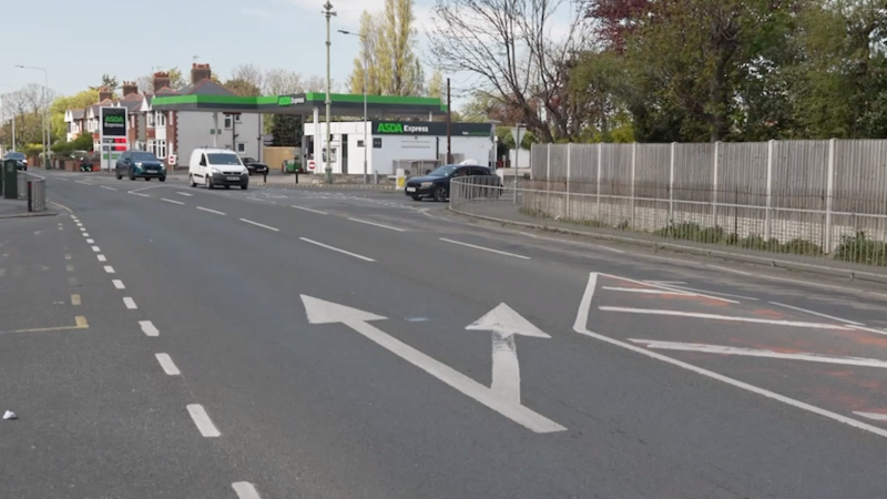 Busy road scene in Rhyl, showing a green petrol station forecourt in the distance