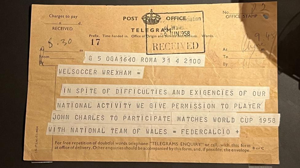 An old telegram on yellow paper with a stamp of 6 June 1958 and writing highlighted in white lines.