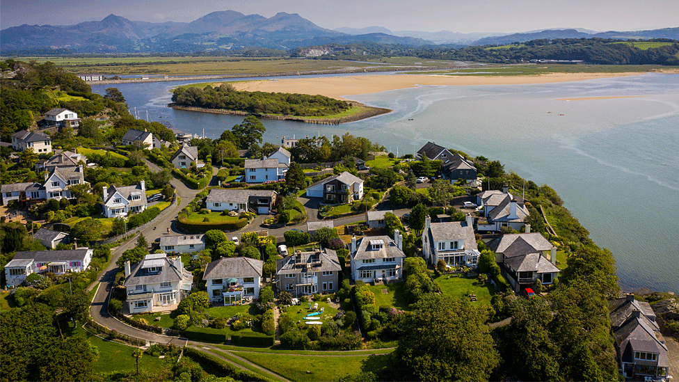 Aerial view of homes overlooking Welsh coast and mountains surrounding Porthmadog