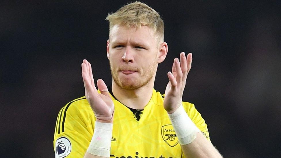Aaron Ramsdale, wearing a yellow Arsenal goalkeeper shirt, claps his hands after a 3-3 draw with Southampton in April 2023