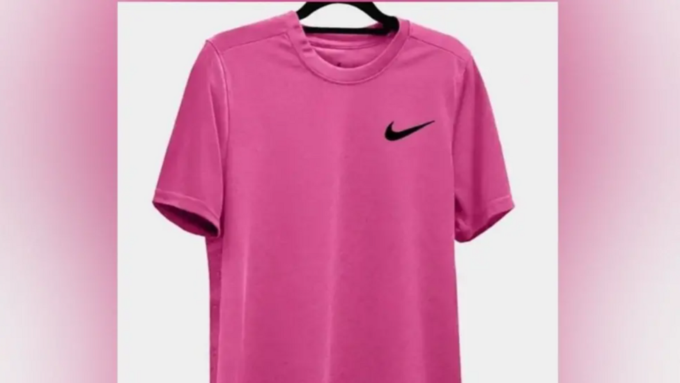 A cerise pink t-shirt, with a black Nike logo on the chest.