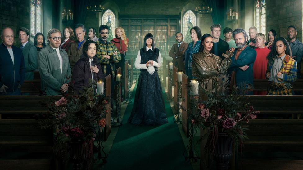 The Celebrity Traitors stood in the pews of a church with Claudia Winkelman standing in the middle; they are all smartly dressed
