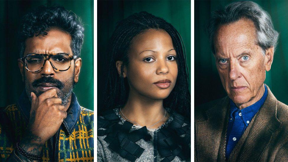 Romesh Ranganathan, Myha'la and Richard E Grant all in smart clothes looking straight at the camera