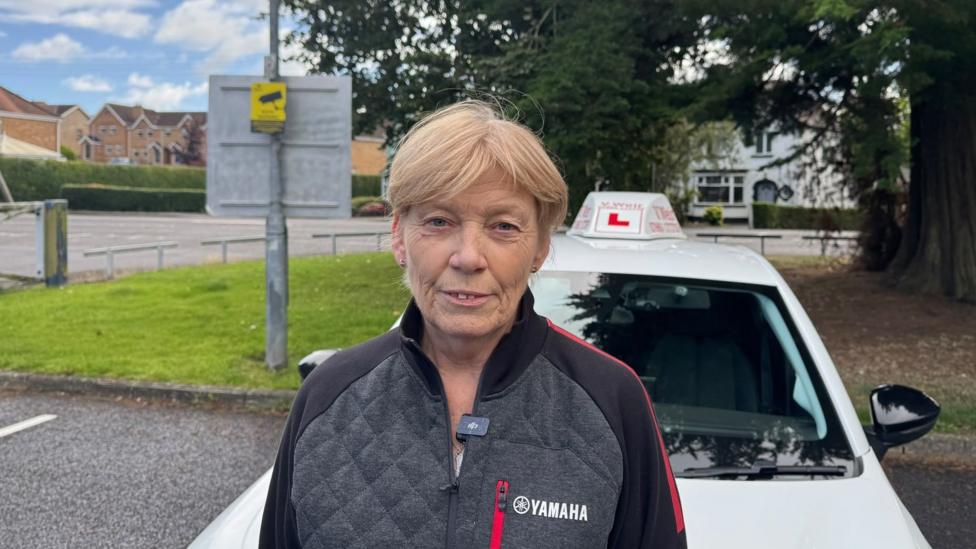 A woman with blonde hair and a Yahama paded jacket