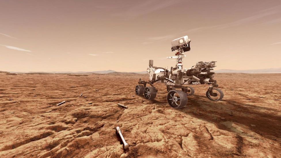 A concept image of Nasa's Perseverance rover. It is a light-weight robot with six wheels and a camera fitted to the end of an antenna. It is rolling across an area of red Martian rocks.