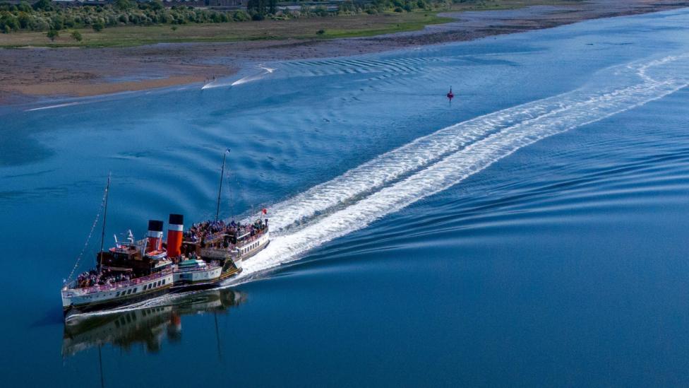 The Waverley, the world's last seagoing paddle steamer, passes Dumbarton Rock as it makes its way along the River Clyde in May 2026.