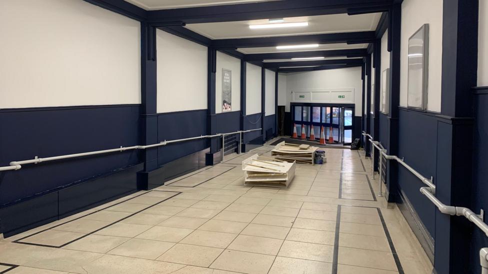 A walkway from the cinema entrance painted in blue and white