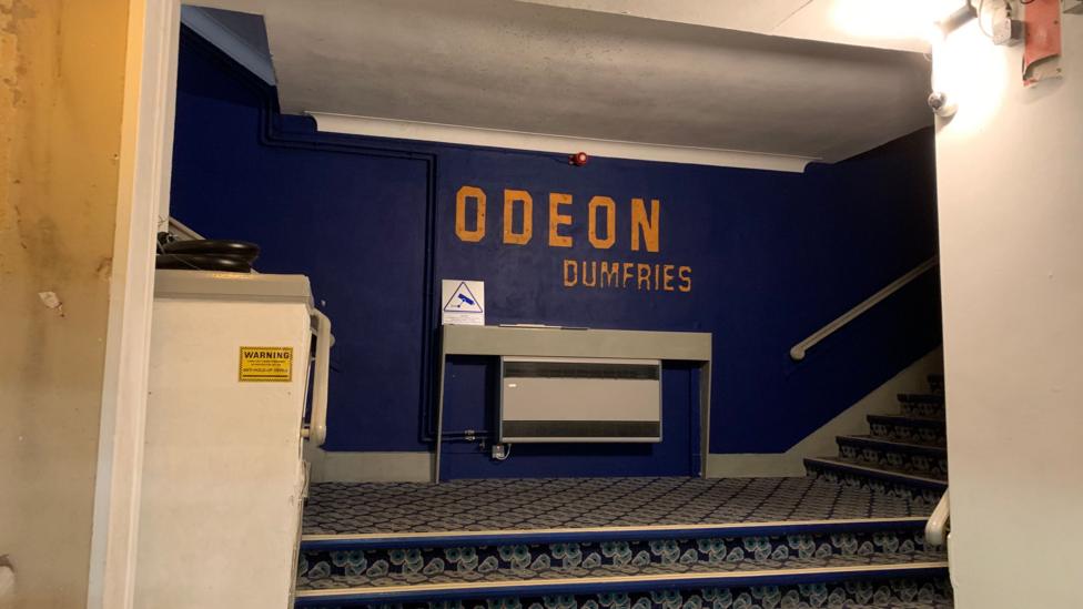 The stairway into Dumfries cinema with Odeon Dumfries written on the wall