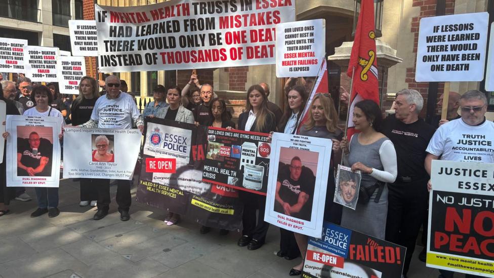 Protesters outside Arundel House in London, where the Lampard Inquiry previously took place. Many are holding pictures of their loved ones or signs asking for justice. There are around 20 people in the picture