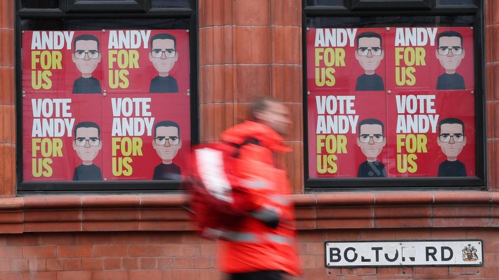 Pictures of Andy Burnham on a window in Makerfield