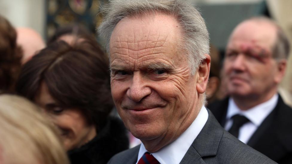 Lord Archer is photographed later in life. He is looking directly at the camera.
