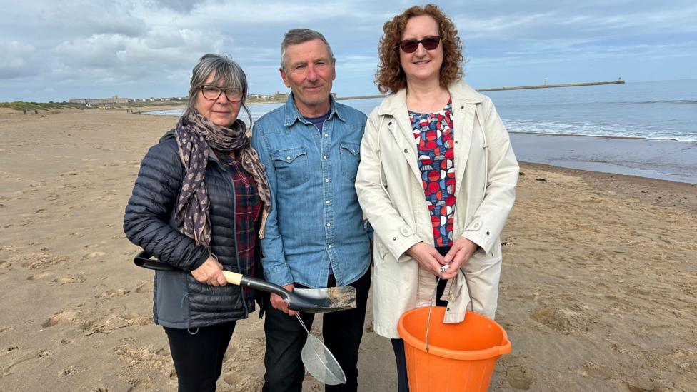 Volunteers stand on South Tyneside Beach. They are equipped with a bucket, spade and sieve which have been used to sort through the sand to find nurdles which have been polluting the beach on South Tyneside. 