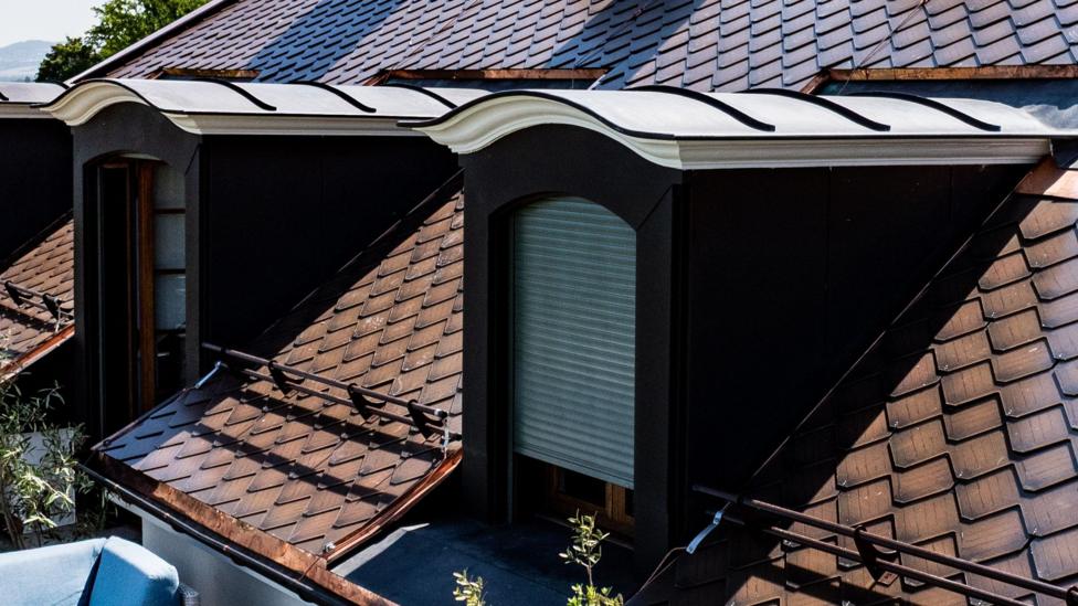 A terracotta solar roof in Vésenaz, Switzerland.