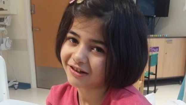 Vian is pictured as a child during one of her many hospital visits for blood transfusions. She is wearing a pink top, and has a slide in her bob length hair.
