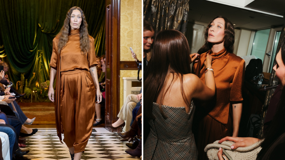 Composite image showing Alana Hadid in an orange silk floaty top and matching trousers. In one image she is walking down a runway in a grand stately home, in the other multiple people are fixing her outfit backstage