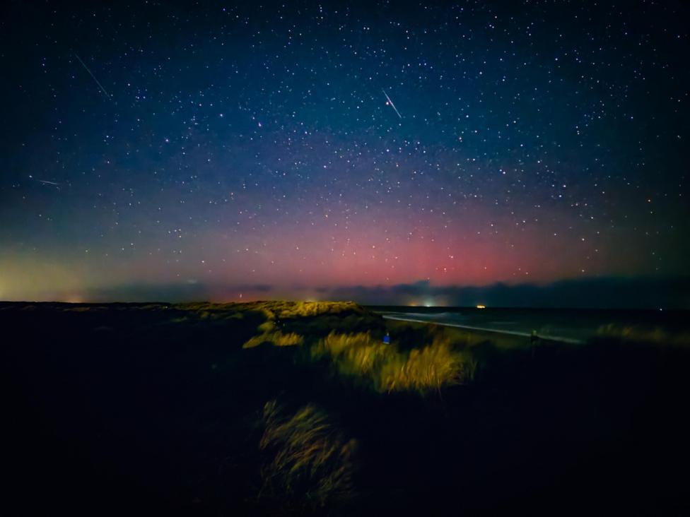 An image of the sky in Winterton-on-Sea, Norfolk, on 9 October during the evening. A pink haze can be seen towards the horizon.