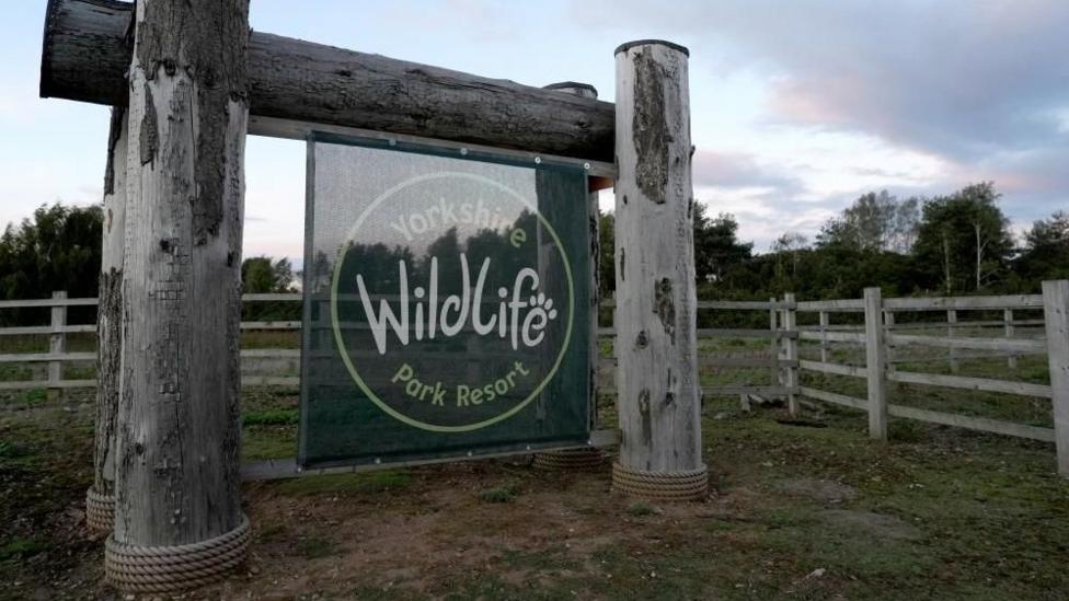 Yorkshire Wildlife Park sign with wooden frame and green fabric 