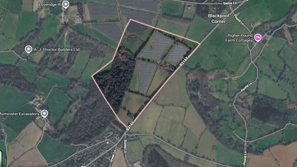 An aerial view of a number of fields shows the site in Axminster.
