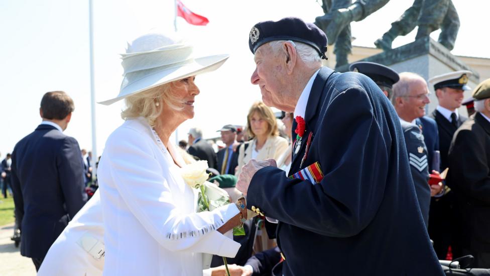 Henry Rice speaks with Queen Camilla following the UK national commemorative event for the 80th anniversary of D-Day.