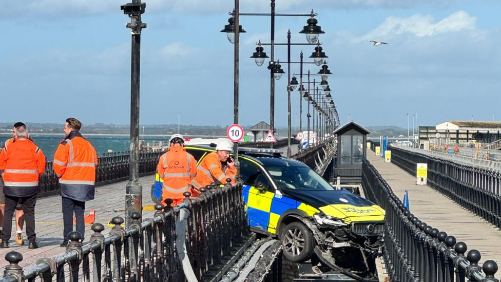 Police car through railings on Ryde Pier.
