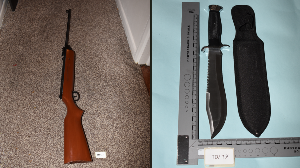 Image of rifle next to knife