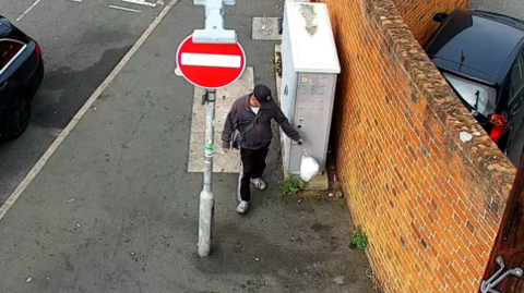 Man drops bag of rubbish on pavement 