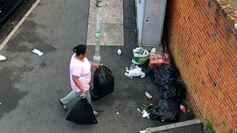 Woman drops bags of rubbish on pavement 