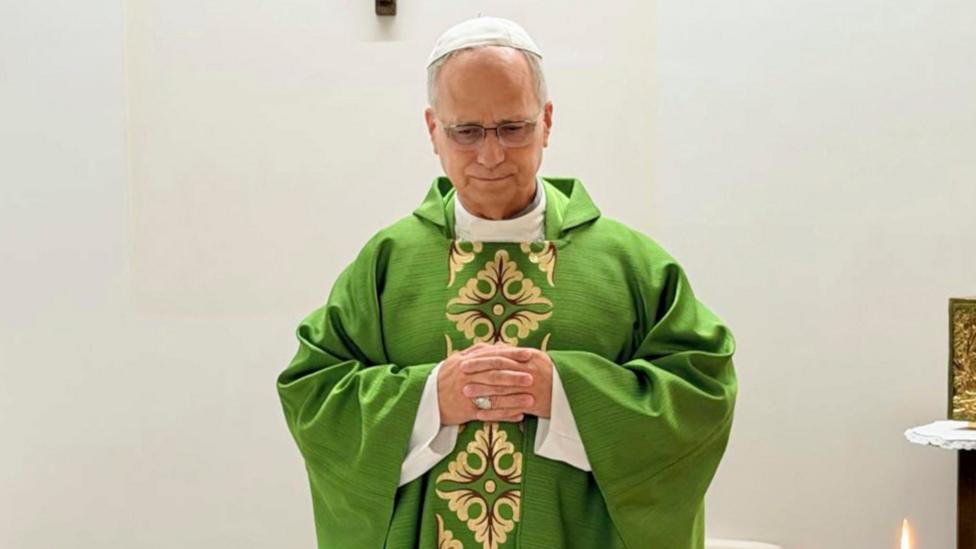 Pope Leo holds his hands in prayer, celebrating a mass