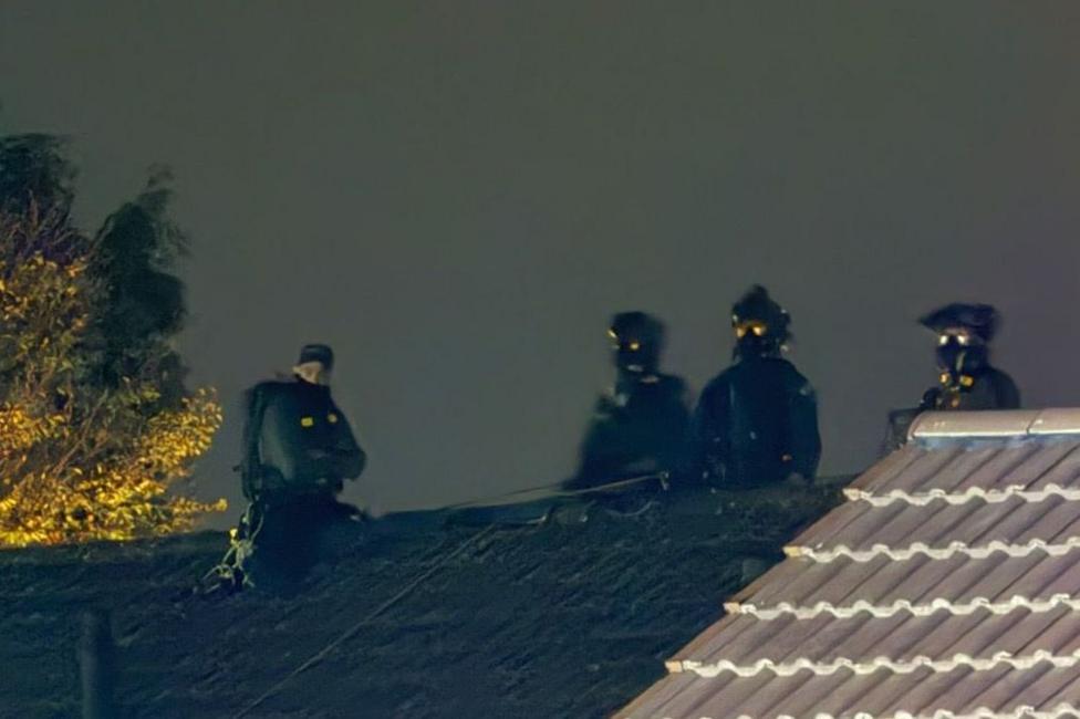Armed police on the roof of sheltered home