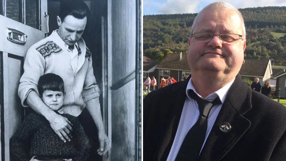 A composite image. The first black and white photo is of a little boy standing in the doorway with his dad's arm around him. In the second photo is Gareth as a grown man with glasses and short white hair, wearing a suit with a black tie.