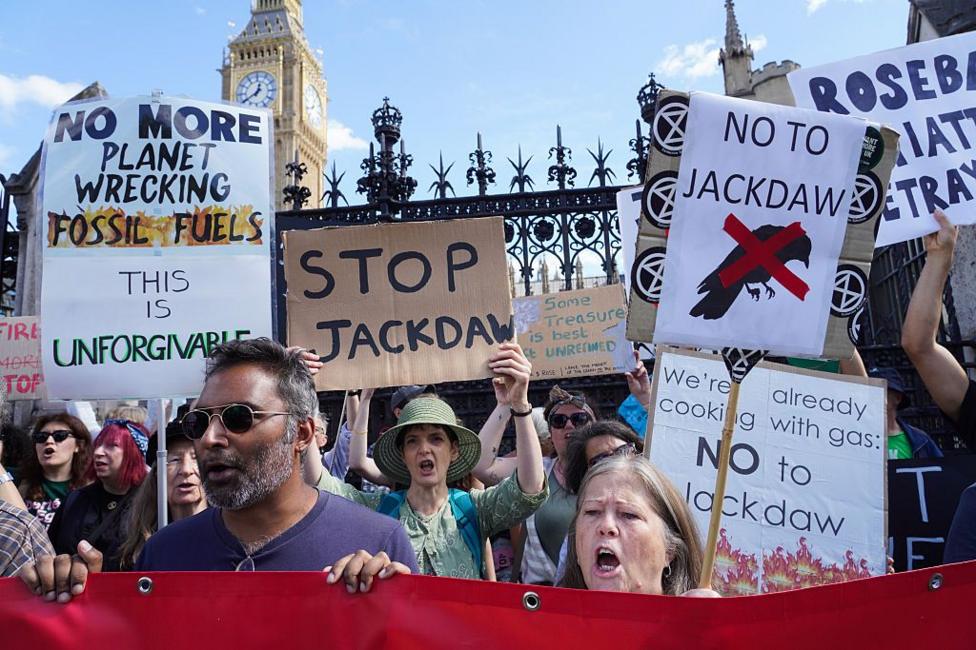 Protesters outside the Houses of Parliament hold up signs stating: "Stop Jackdaw", "No more planet wrecking fossil fuels this is unforgivable" and "No to Jackdaw".