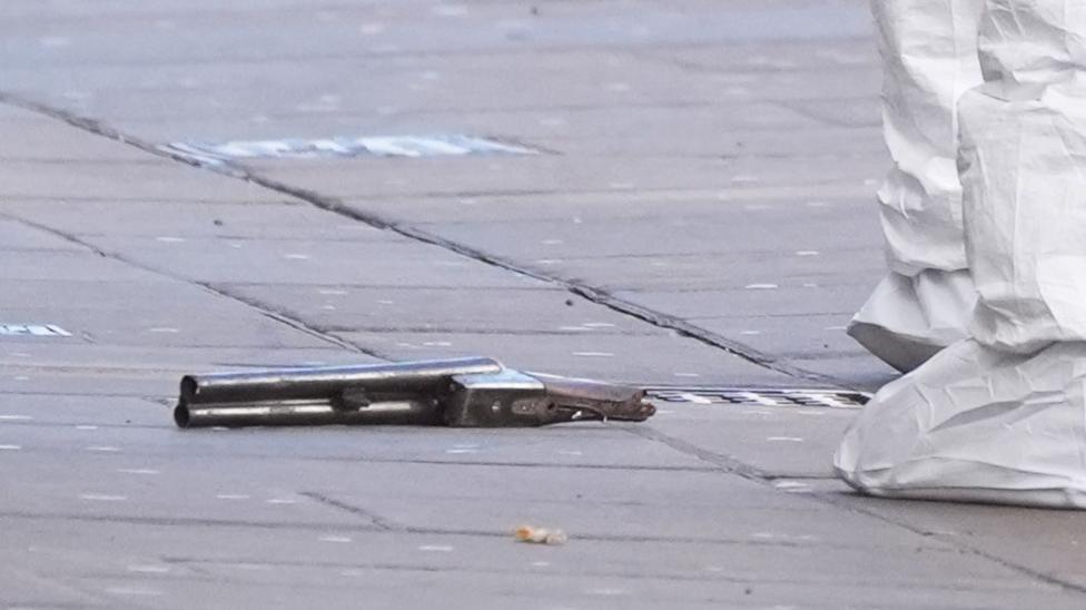 A short-barrelled shot gun on the floor