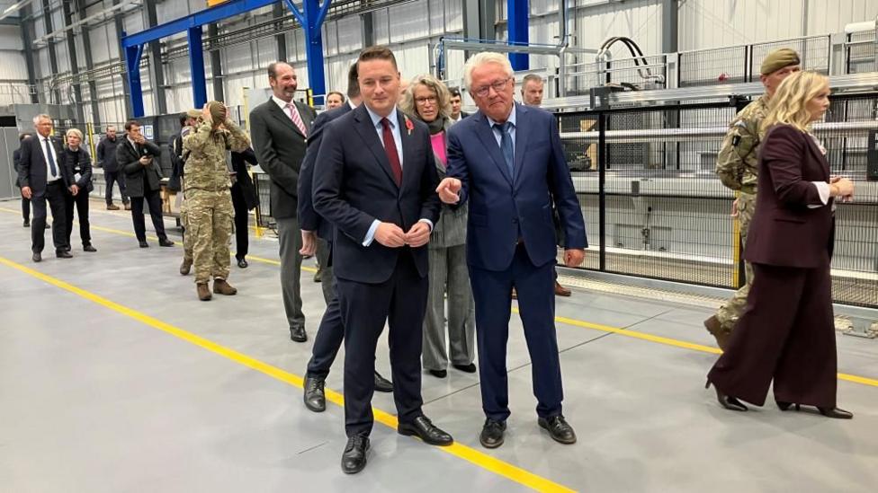 Wes Streeting talking to another man at a Gun Hall opening in Telford