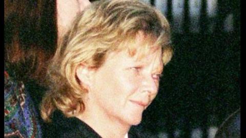 Rosemary Nelson had wavy blonde hair that came down in a fringe and was swept back over her ears and came down blow her collar. We can only see her head and a black collar. The picture is a side profile.