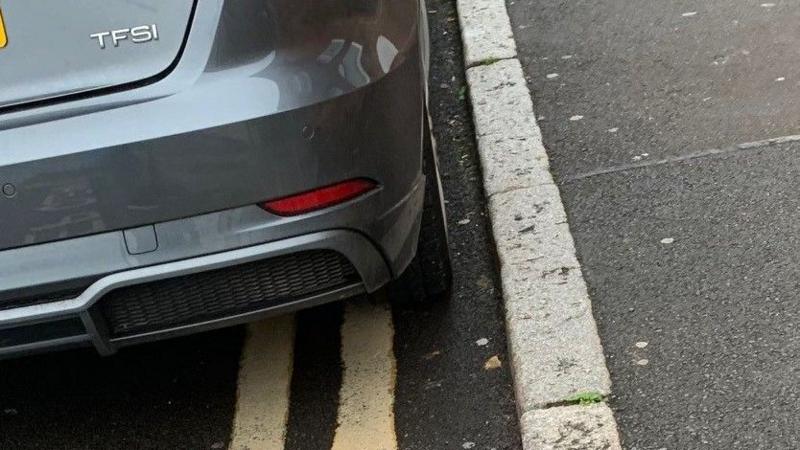 A car parked on double yellow lines