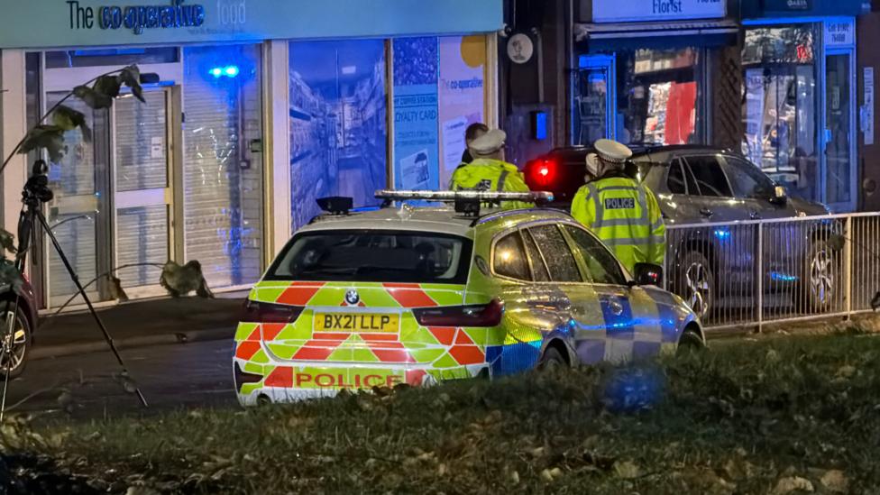 A police car on a street at night