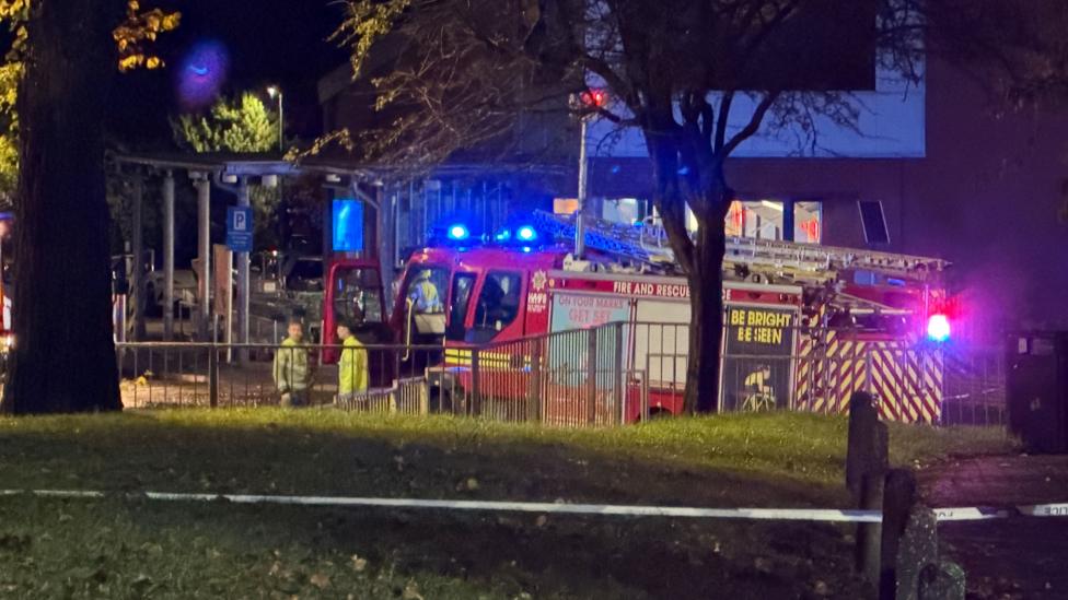 A fire engine on a street at night.