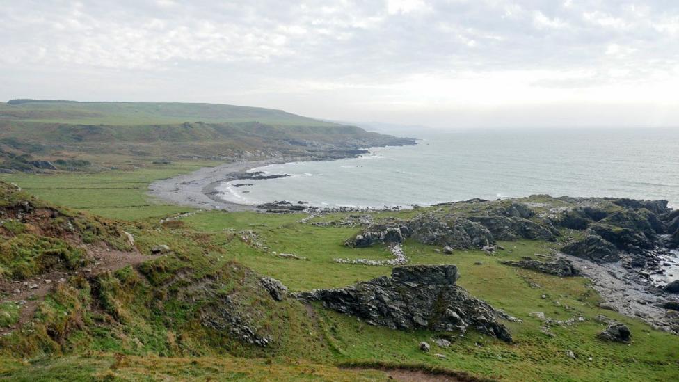 A view of the coastline of Galloway with a curved bay and cliffs
