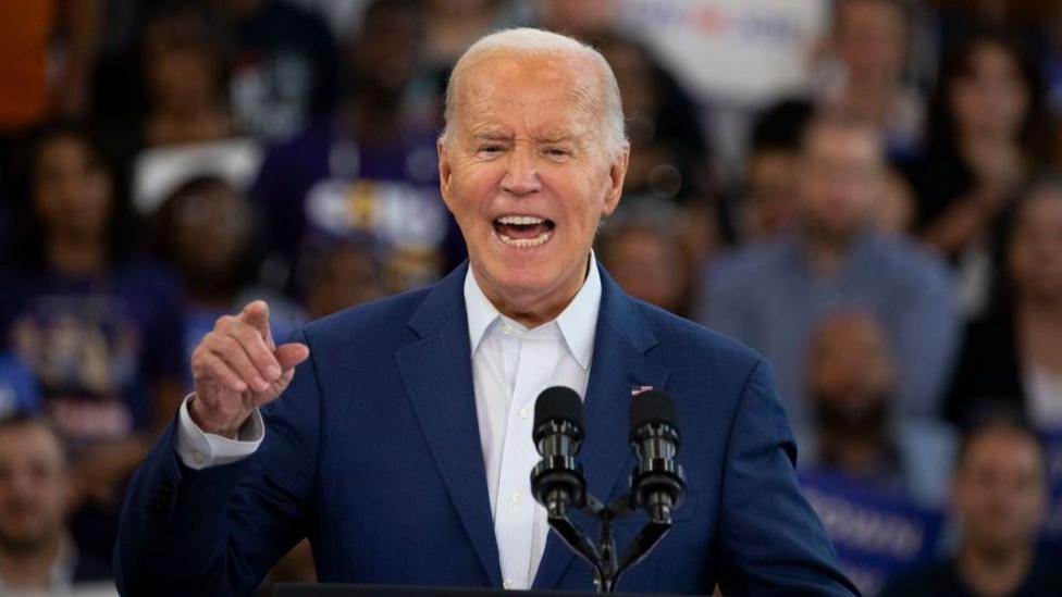 US President Joe Biden at a campaign event at Renaissance High School on July 12, 2024 in Detroit, Michigan. He wears a blue suit jacket and a white shirt