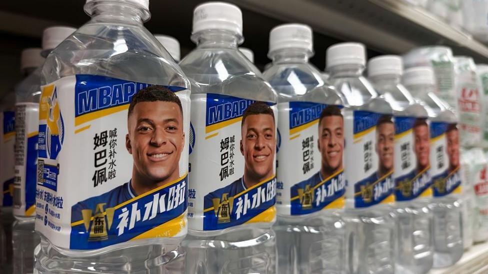 Bottles of Dongpeng Bushuila electrolyte beverages produced by Eastroc Beverage featuring images of French footballer and brand ambassador Kylian Mbappe