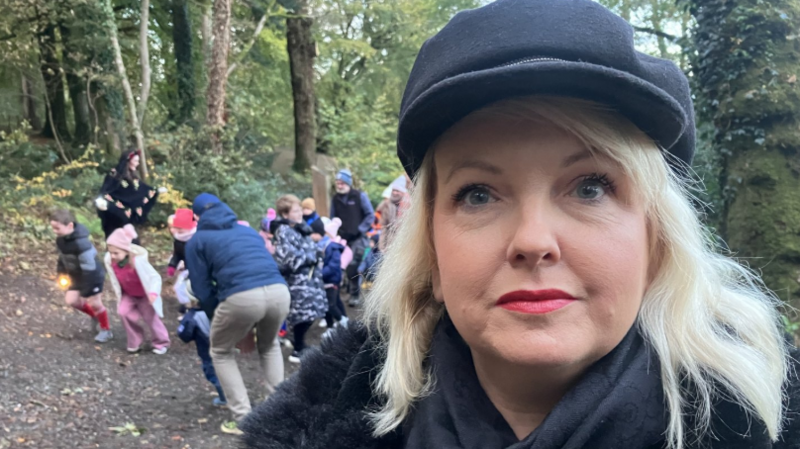 Rozlyn Sheridan, who has long, blonde hair and wears a black peak cap and a black coat.