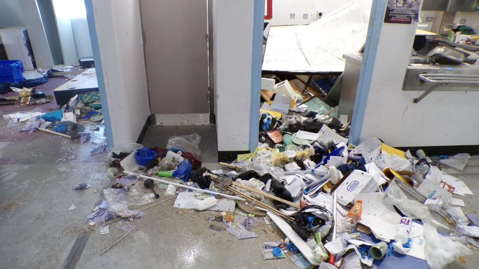 An image showing items strewn across the floor at HMP Polmont.