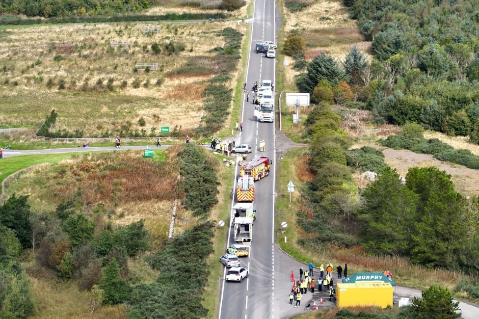 An aerial view of the exercise area with a long road and various vehicles on it, including police, fire and ambulance.