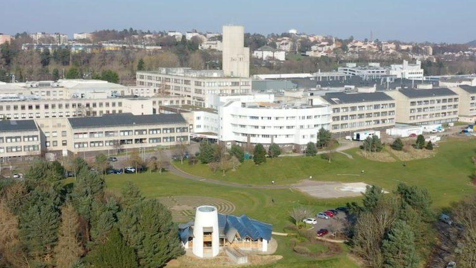 A far shot of the Ninewells Hospital complex, with several grey buildings of three or four storeys